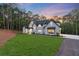 Beautifully landscaped home with black roof and modern architectural design at 5567 Tyree Rd, Winston, GA 30187
