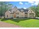 Beautiful home with a manicured lawn and a mix of traditional and modern architecture among mature trees at 5567 Tyree Rd, Winston, GA 30187