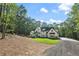 Stunning home exterior with manicured lawn and lush trees, showcasing the home's elegant design at 5567 Tyree Rd, Winston, GA 30187