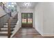Bright foyer features wood-look floors, double entry doors, staircase, and a large window letting in natural light at 5567 Tyree Rd, Winston, GA 30187