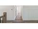 Hallway featuring hardwood floors and white trim, leading to open doorways at 5567 Tyree Rd, Winston, GA 30187