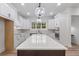 Bright kitchen featuring white cabinets, stainless steel appliances, and a large center island with a stone countertop at 5567 Tyree Rd, Winston, GA 30187