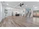 Spacious open floor plan with wood floors, a staircase, and kitchen in the background at 5567 Tyree Rd, Winston, GA 30187