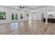 Expansive open floor plan with wood floors, a living room, and kitchen in the background at 5567 Tyree Rd, Winston, GA 30187