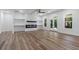 Open-concept living room featuring a modern fireplace, built-in shelves, and double glass doors to the backyard at 5567 Tyree Rd, Winston, GA 30187
