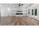 Bright living room with a modern fireplace, white shelves, and glass doors leading to the backyard at 5567 Tyree Rd, Winston, GA 30187