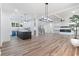 A bright living room offers an open-concept layout, modern fireplace, a ceiling fan and wood floors at 5567 Tyree Rd, Winston, GA 30187