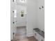 Bright mudroom featuring bench seating and durable laminate flooring that compliments the fresh white walls at 5567 Tyree Rd, Winston, GA 30187