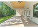 Covered patio featuring an open beam ceiling with fans, overlooking a lush green backyard, perfect for outdoor living at 5567 Tyree Rd, Winston, GA 30187