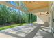 Covered back patio with ceiling fans offers views of a private wooded backyard and a shady place to relax at 5567 Tyree Rd, Winston, GA 30187
