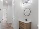 Well-lit powder room featuring a wood vanity with modern fixtures at 5567 Tyree Rd, Winston, GA 30187