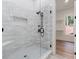 Modern bathroom showcases a tiled shower with a frameless glass door and matte black fixtures at 5567 Tyree Rd, Winston, GA 30187