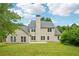 The home's backyard features a well-manicured lawn, a concrete patio, and mature trees at 6027 Windfall Ct, Powder Springs, GA 30127