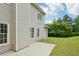 The home's backyard features a well-manicured lawn, a concrete patio, and mature trees at 6027 Windfall Ct, Powder Springs, GA 30127