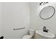 Powder room featuring modern sink, toilet, mirror, and black fixtures at 6027 Windfall Ct, Powder Springs, GA 30127