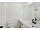Bright bathroom with toilet, sink, and a large vanity mirror at 6027 Windfall Ct, Powder Springs, GA 30127