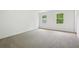 Large carpeted bedroom with two windows, white walls, and natural light at 6027 Windfall Ct, Powder Springs, GA 30127