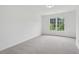 Bright bedroom with a large window at 6027 Windfall Ct, Powder Springs, GA 30127