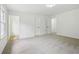 A bright and spacious bedroom features neutral carpet, fresh white paint, and ample natural light at 6027 Windfall Ct, Powder Springs, GA 30127