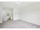 A bright and spacious bedroom features neutral carpet, fresh white paint, and ample natural light at 6027 Windfall Ct, Powder Springs, GA 30127