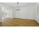 Bright dining room features wood floors, stylish lighting, and elegant trim at 6027 Windfall Ct, Powder Springs, GA 30127