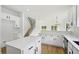 Open kitchen featuring white cabinets, quartz countertops, stainless steel appliances, subway tile backsplash, and an island at 6027 Windfall Ct, Powder Springs, GA 30127