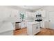 Modern kitchen featuring quartz countertops, white cabinets, subway tile backsplash, stainless steel appliances, and an island at 6027 Windfall Ct, Powder Springs, GA 30127