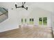 Bright living room features vaulted ceiling, wood floors, and large windows at 6027 Windfall Ct, Powder Springs, GA 30127