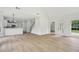 Spacious living room with luxury vinyl plank flooring, modern lighting, and an open floor plan to the kitchen at 6027 Windfall Ct, Powder Springs, GA 30127
