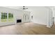 Bright living room featuring wood floors, fireplace, and white trim at 6027 Windfall Ct, Powder Springs, GA 30127