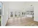 Bright, open-concept living room featuring luxury vinyl plank flooring, high ceilings, and lots of natural light at 6027 Windfall Ct, Powder Springs, GA 30127