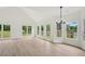 Open living space with wood floors, vaulted ceiling, and multiple windows at 6027 Windfall Ct, Powder Springs, GA 30127