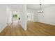 Spacious open-concept living room with wood floors and bright white walls at 6027 Windfall Ct, Powder Springs, GA 30127