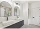 Contemporary bathroom featuring double sinks, modern fixtures, and a large mirror at 1355 Lockwood Sw Dr, Atlanta, GA 30311