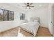Bright bedroom with a queen bed, wood floors, and large black-trimmed windows at 1355 Lockwood Sw Dr, Atlanta, GA 30311