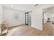 Bright bedroom with wood floors and view to en suite bathroom through sliding barn door at 1355 Lockwood Sw Dr, Atlanta, GA 30311