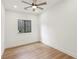 Clean, neutral bedroom with wood floors, black trim window, and ample natural light at 1355 Lockwood Sw Dr, Atlanta, GA 30311