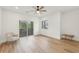 Spacious bedroom with wood floors, recessed lights, ceiling fan, balcony access, and large window at 1355 Lockwood Sw Dr, Atlanta, GA 30311