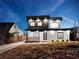 Striking modern home exterior at dusk with well-lit windows and landscaped front yard at 1355 Lockwood Sw Dr, Atlanta, GA 30311