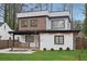 Two-story house featuring a modern design with a small front yard and a combination of white brick and brown siding at 1355 Lockwood Sw Dr, Atlanta, GA 30311