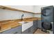 Well-organized laundry room with butcher block countertops, a farmhouse sink, and new washer and dryer at 1355 Lockwood Sw Dr, Atlanta, GA 30311