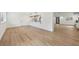Spacious living area featuring wood floors and open to the kitchen bar at 1355 Lockwood Sw Dr, Atlanta, GA 30311