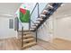 Unique floating staircase with wood treads, metal railings, and eye-catching green and red art at 1355 Lockwood Sw Dr, Atlanta, GA 30311