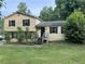 Charming home with a classic yellow exterior, surrounded by lush greenery and a well-maintained front yard at 2940 Caller Ct, Marietta, GA 30060