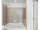 Bathroom featuring a tiled tub and shower combo with a white door at 361 17Th Nw St # 2607, Atlanta, GA 30363
