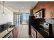 Modern kitchen with stainless steel appliances and black tile backsplash at 361 17Th Nw St # 2607, Atlanta, GA 30363
