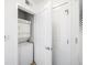 Laundry room with white stacked washer and dryer and storage at 361 17Th Nw St # 2607, Atlanta, GA 30363