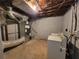 Unfinished basement featuring the laundry hookups, a utility sink, and access to essential home systems at 3796 Leesburg Sw Ct, Atlanta, GA 30331