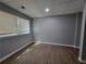 Finished basement area with laminate flooring, drop ceiling, and window at 3796 Leesburg Sw Ct, Atlanta, GA 30331