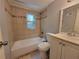 Well-lit bathroom with a tub-shower combo and a neutral-toned tile surround plus window for natural light at 3796 Leesburg Sw Ct, Atlanta, GA 30331